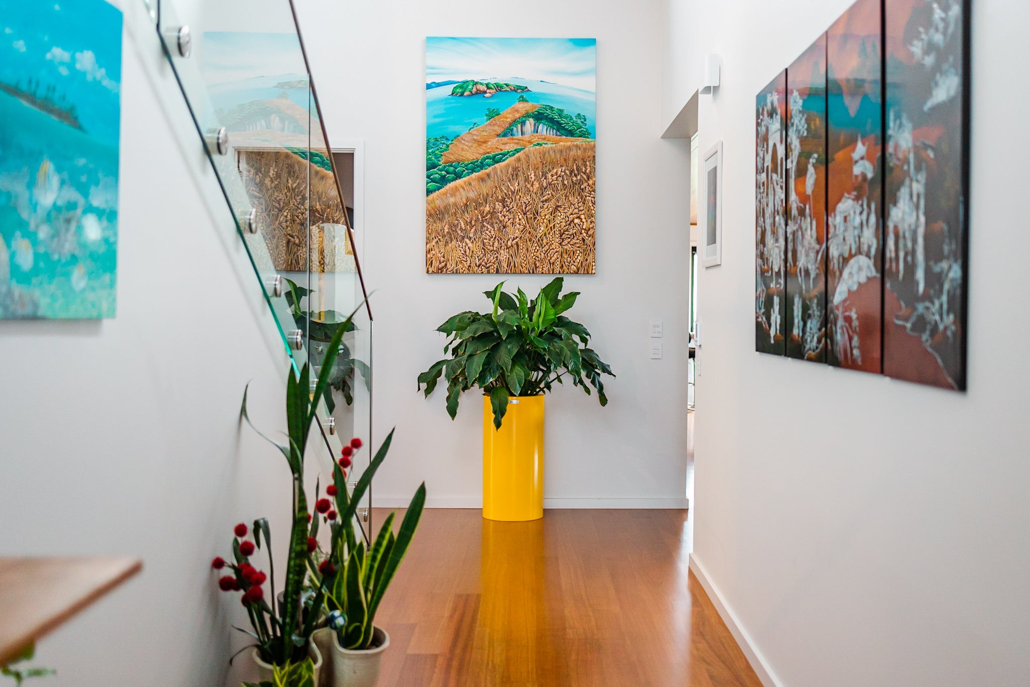 A tall cigar planter in yellow inside a house at the end of a hallway.