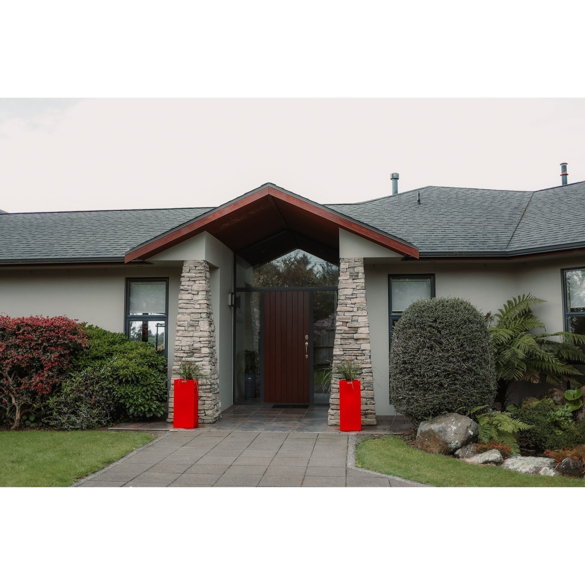 Cube planters in red in front of house entranceway pillars. Modscene planters.