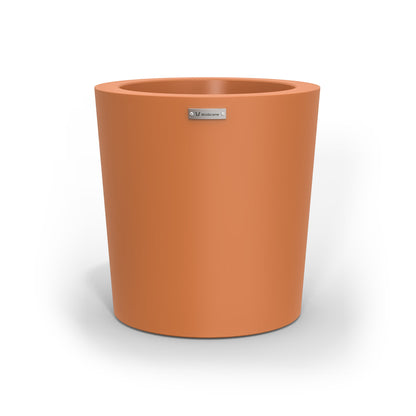 A modern designer planter pot in a smooth terracotta colour. 