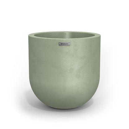A Modscene planter pot in a pastel green colour with a concrete look finish.