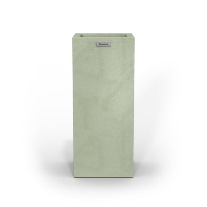 A tall cube planter pot in a pastel green colour with a concrete look finish.