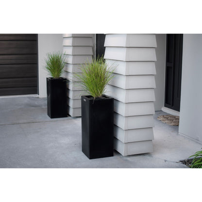 Cube planters in black planted with grasses. 