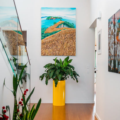 A yellow Modscene planter at the end of a hallway in a house.